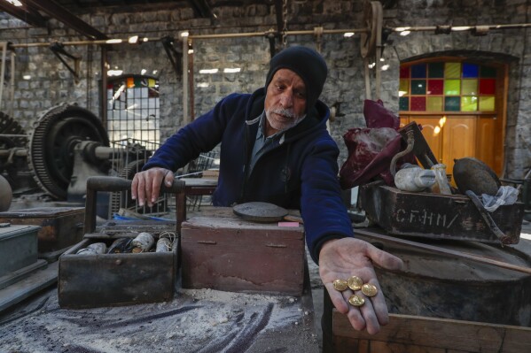 Train operator Mazen Malla inspects the Qadam train station, which was damaged during the war between rebel forces and ousted President Bashar Assad's forces, in Damascus, Syria, Monday, Jan. 13, 2025. (AP Photo/Omar Sanadiki)